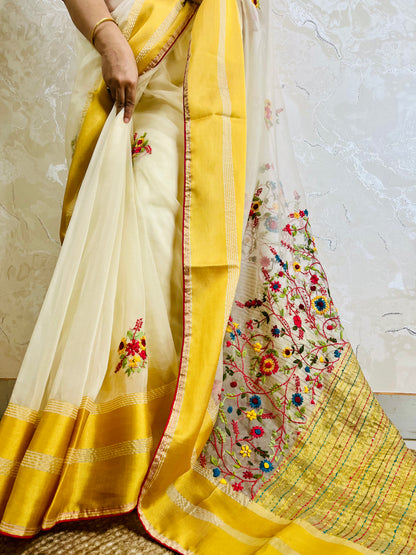 Close-up of Bullion Stitch wild floral and French knot hand embroidery on off white pure organza silk saree with yellow border — Desi Aadat
