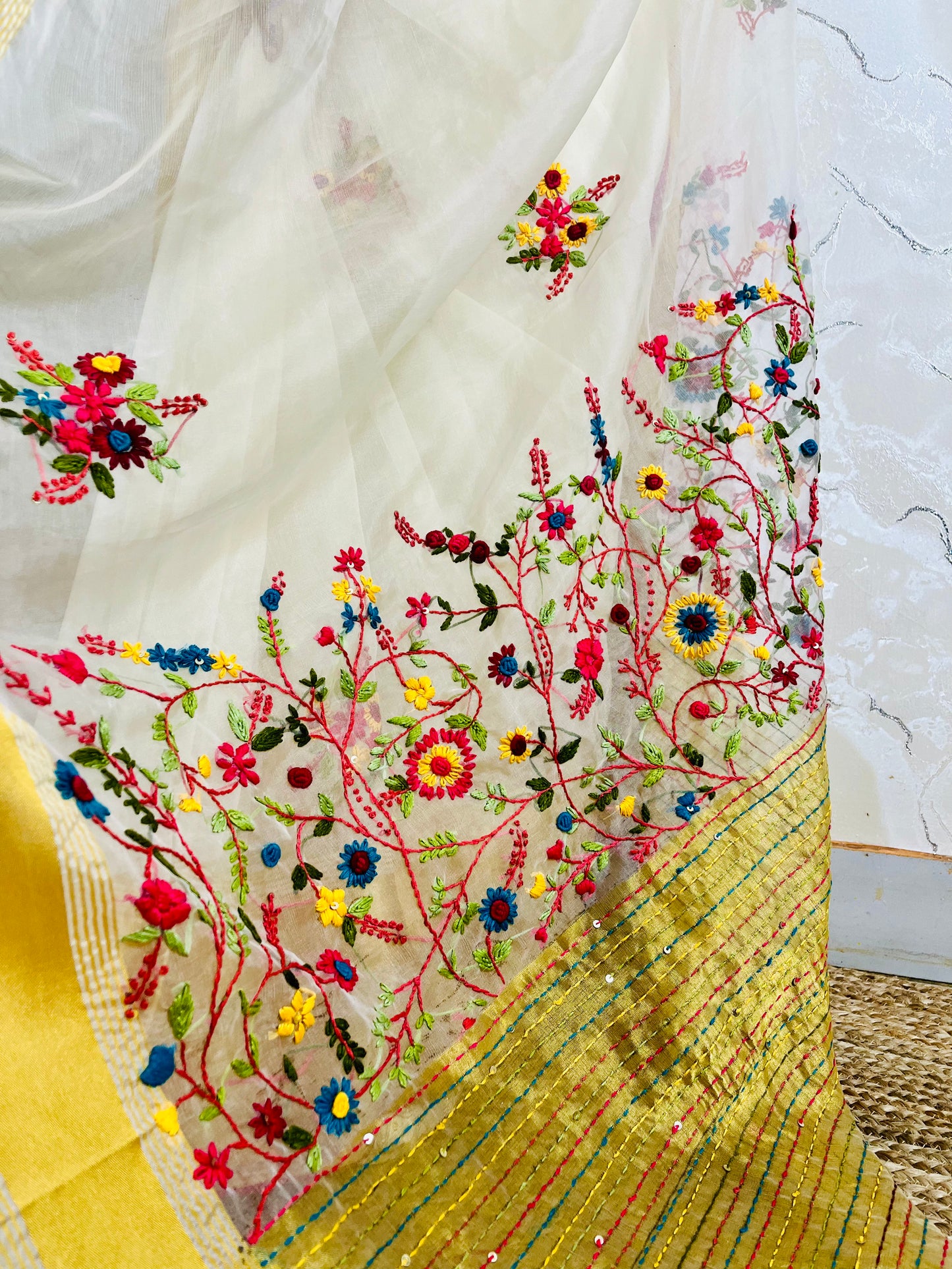 Close-up of Bullion Stitch wild floral and French knot hand embroidery on off white pure organza silk saree with yellow border — Desi Aadat