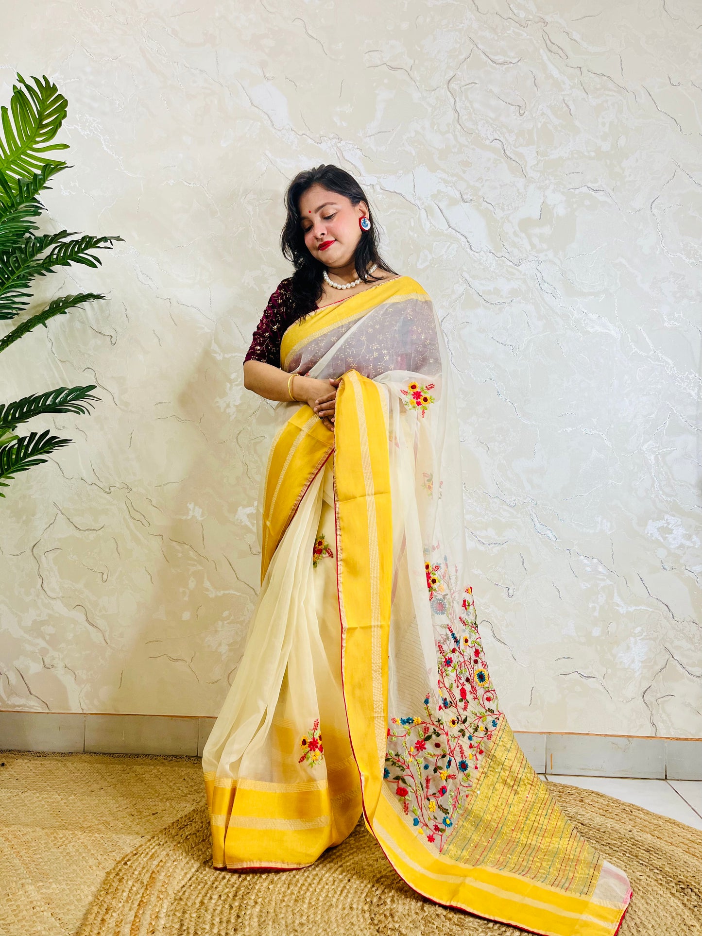 Handcrafted off white organza silk saree with multicolour Bullion Stitch floral embroidery and golden yellow woven border — side standing view, Desi Aadat