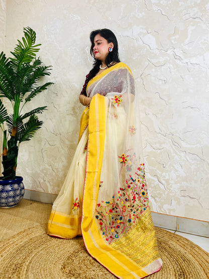 Handcrafted off white organza silk saree with multicolour Bullion Stitch floral embroidery and golden yellow woven border — side standing view, Desi Aadat
