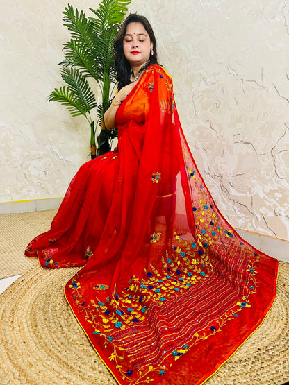 Handcrafted red organza silk saree with multicolour bullion stitch floral embroidery draped on model, side sitting view — Desi Aadat