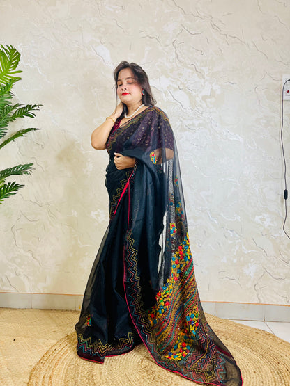 Beautiful woman in pure Black Organza Saree showcasing vibrant Bullion Stitch and French knot embroidered pallu — exclusive handcrafted ethnic wear by Desi Aadat