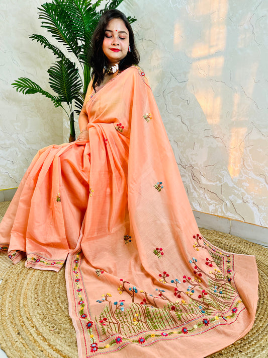 Woman seated in pastel peach Chanderi silk cotton saree with hand-embroidered Bullion Stitch and French Knot floral border – Desi Aadat