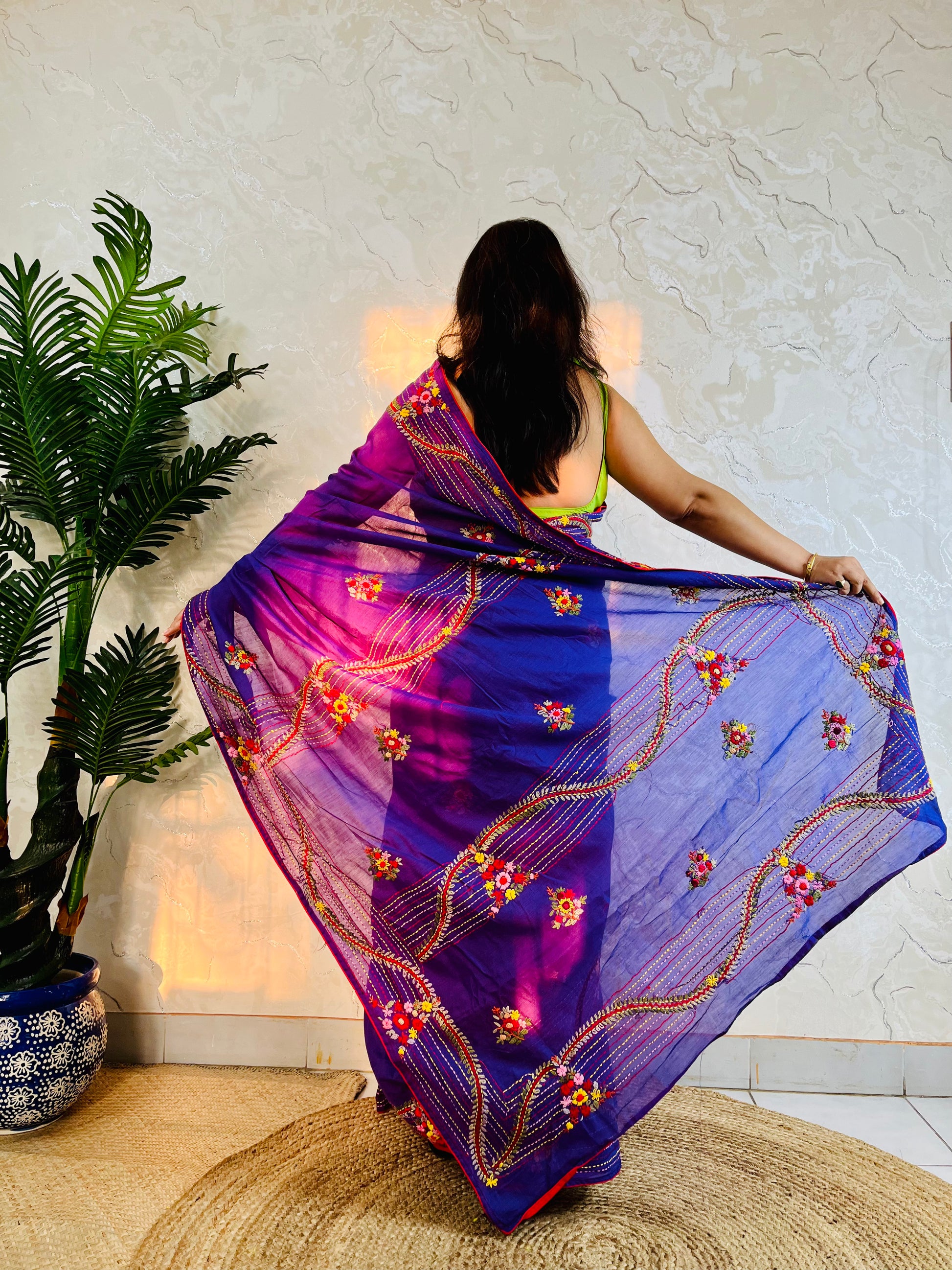 Close-up of hand-embroidered bullion stitch florals on pallu of violet Chanderi silk cotton saree, sitting pose