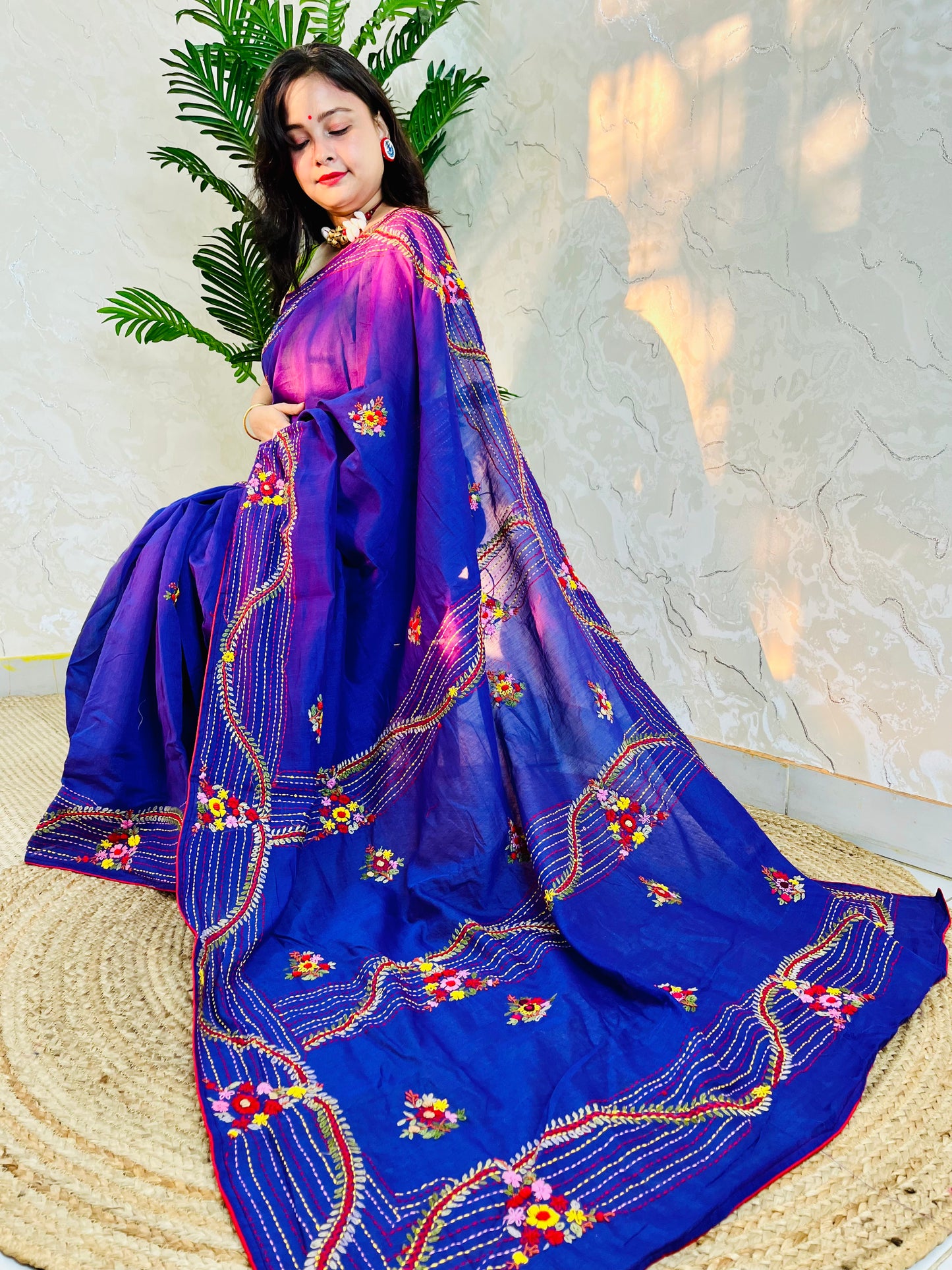Woman draped in violet Chanderi silk cotton saree with raised bullion stitch embroidery, pallu flowing back view