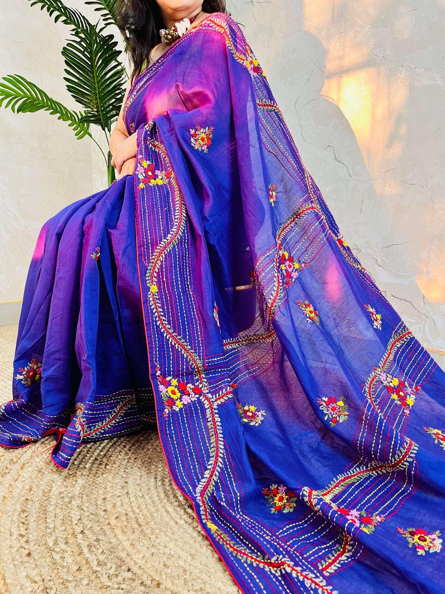 Close-up of hand-embroidered bullion stitch florals on pallu of violet Chanderi silk cotton saree, sitting pose