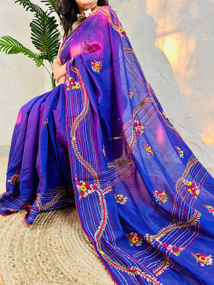 Close-up of hand-embroidered bullion stitch florals on pallu of violet Chanderi silk cotton saree, sitting pose