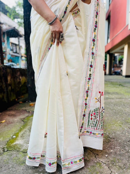 Close-up of handcrafted Bullion Stitch and French Knot wildflower meadow embroidery on cream Chanderi silk cotton saree pallu — outdoor view, Desi Aadat