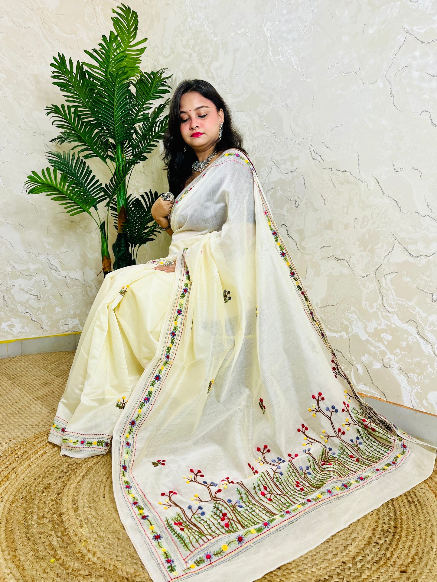 Handcrafted cream Chanderi silk cotton saree with multicolour French Knot and Bullion Stitch forest embroidery — sitting indoor view, Desi Aadat