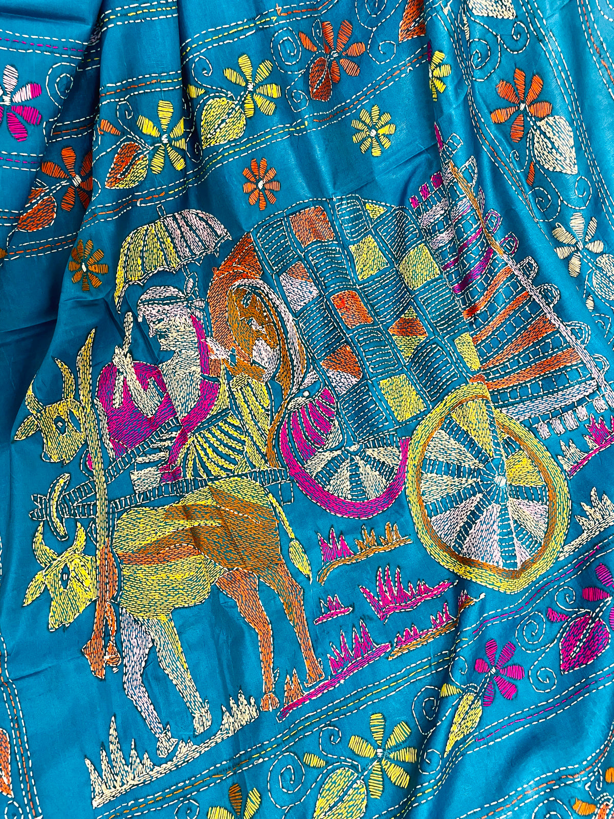 Close-up of bullock cart Kantha embroidery on peacock blue Bangalore silk saree