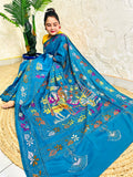 Peacock blue Kantha stitch saree with hand-embroidered bullock cart scene, seated view