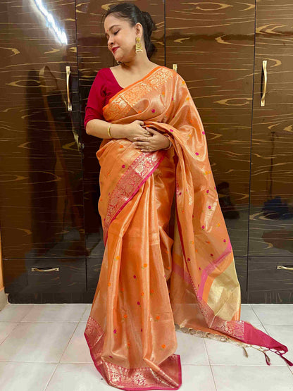 Close-up of embroidery on Orange cotton tissue saree fabric