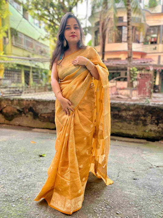 Elegant woman in Peach crush tissue saree showcasing Desi Aadat’s handwoven design