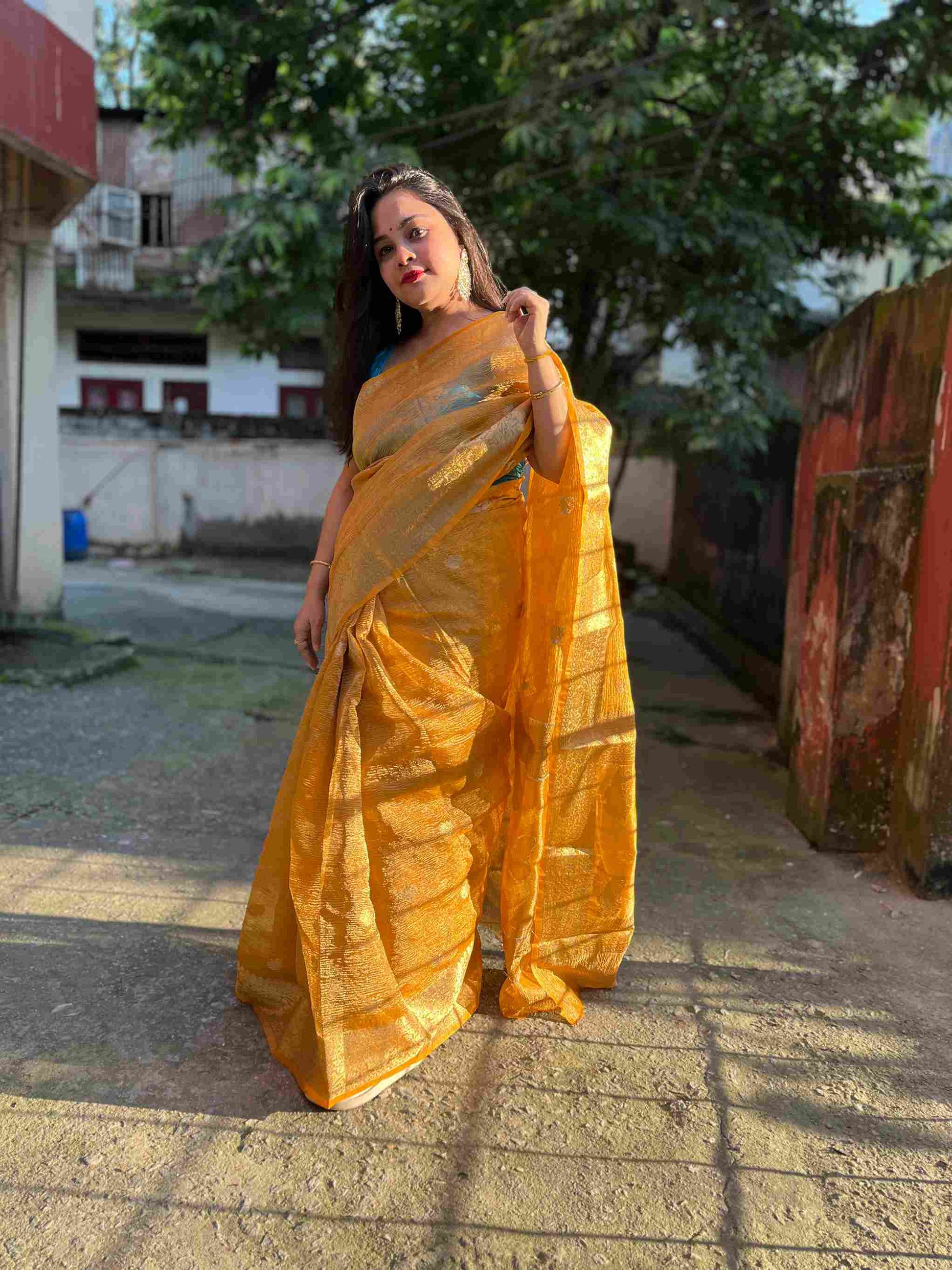 Close-up of crushed silk tissue fabric on Peach banarasi tissue saree