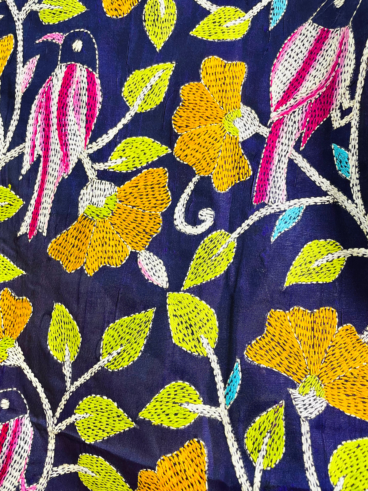Close-up of hand-stitched Kantha bird and floral embroidery on navy blue Bangalore silk