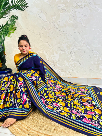 Woman draping navy blue Kantha stitch Bangalore silk saree with bird motif border