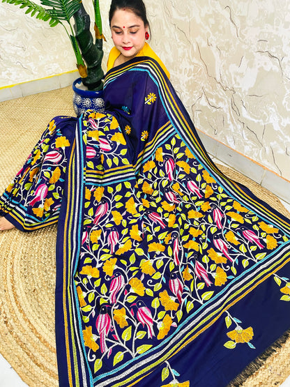 Woman draping navy blue Kantha stitch Bangalore silk saree with bird motif border