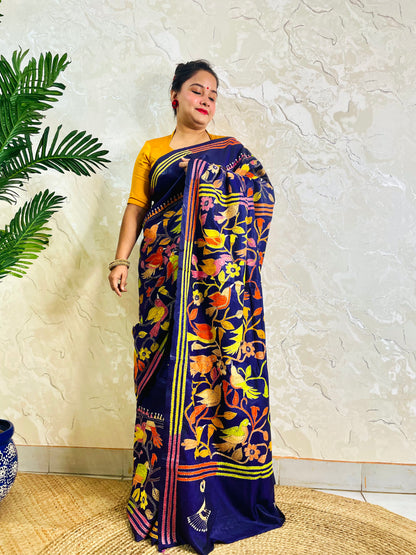 Detail view of gold and coral bird embroidery on royal blue Kantha stitch saree