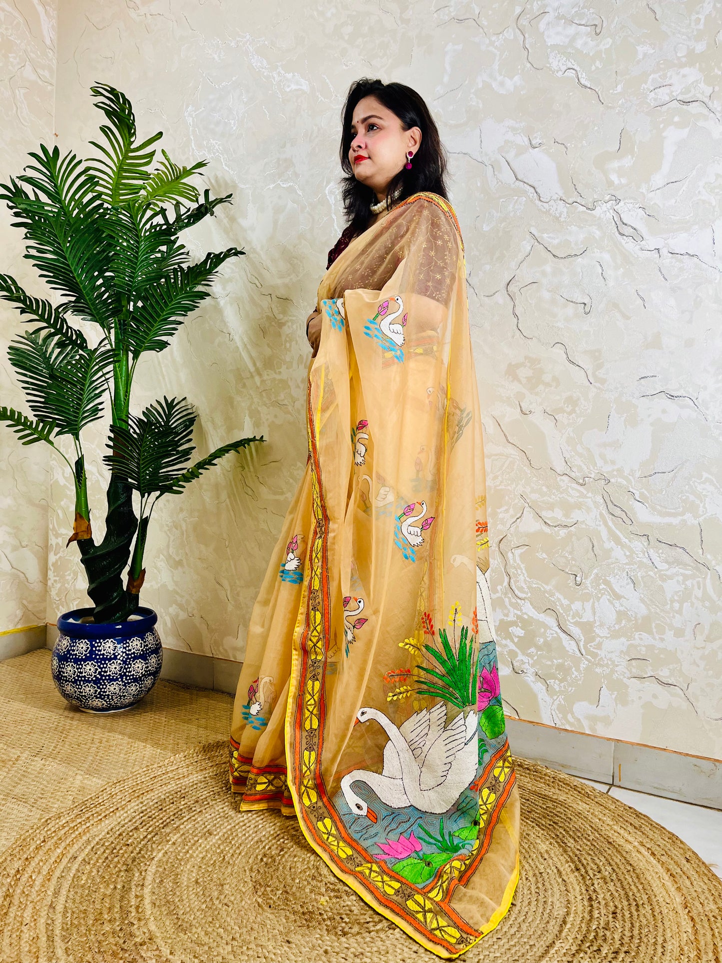 Beige-gold Kantha stitch organza saree with swan and lotus motif, front standing drape view