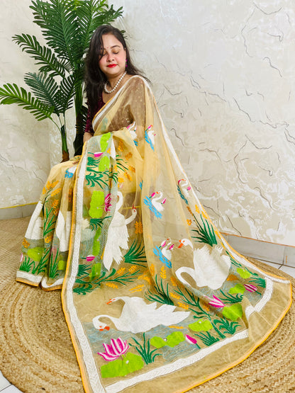 Handcrafted swan and lotus Kantha stitch saree in beige gold, seated draped view