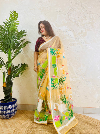 Beige gold organza saree with hansa swan and lotus motif, front standing view