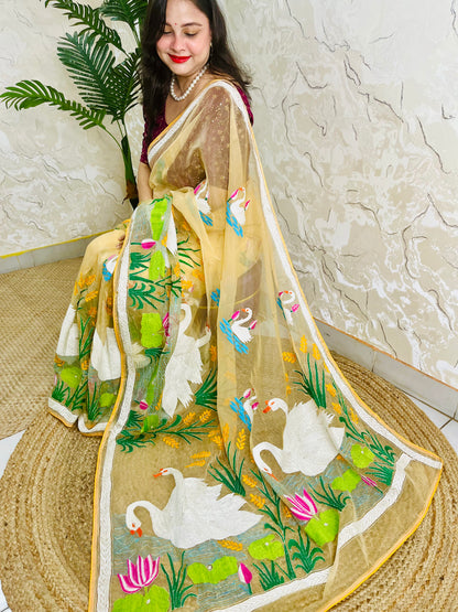 Handcrafted swan and lotus Kantha stitch saree in beige gold, seated draped view