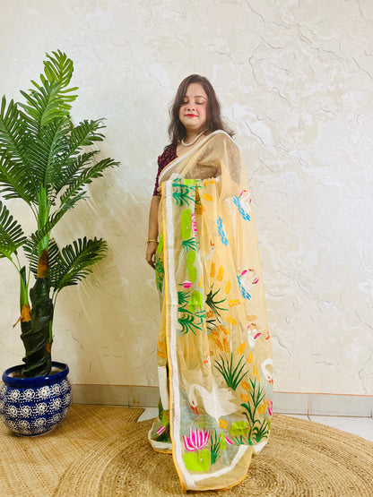 Beige gold organza saree with hansa swan and lotus motif, front standing view