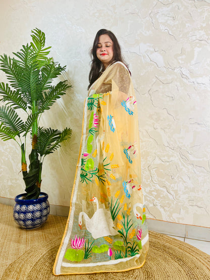 Beige gold organza saree with hansa swan and lotus motif, front standing view