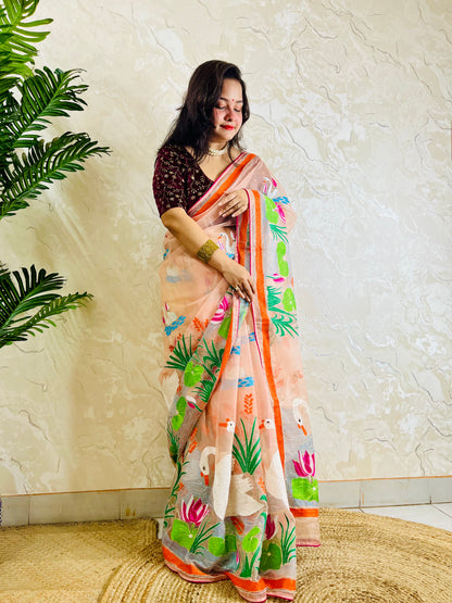 Close-up of Kantha stitch embroidery showing swans, lotus flowers and leaves on peach-pink organza saree