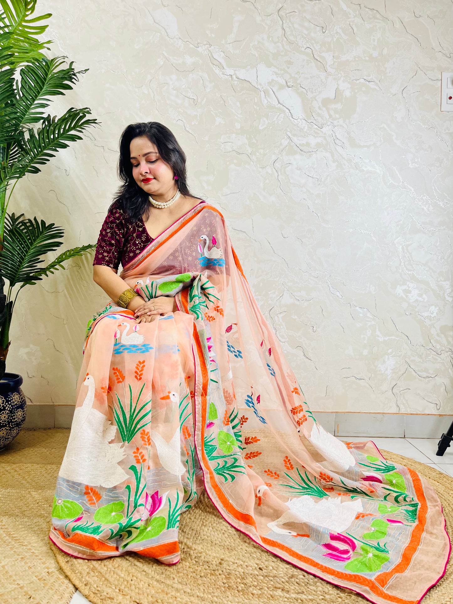 Detailed pallu close-up of handcrafted swan and lotus Kantha embroidery on sheer organza saree fabric