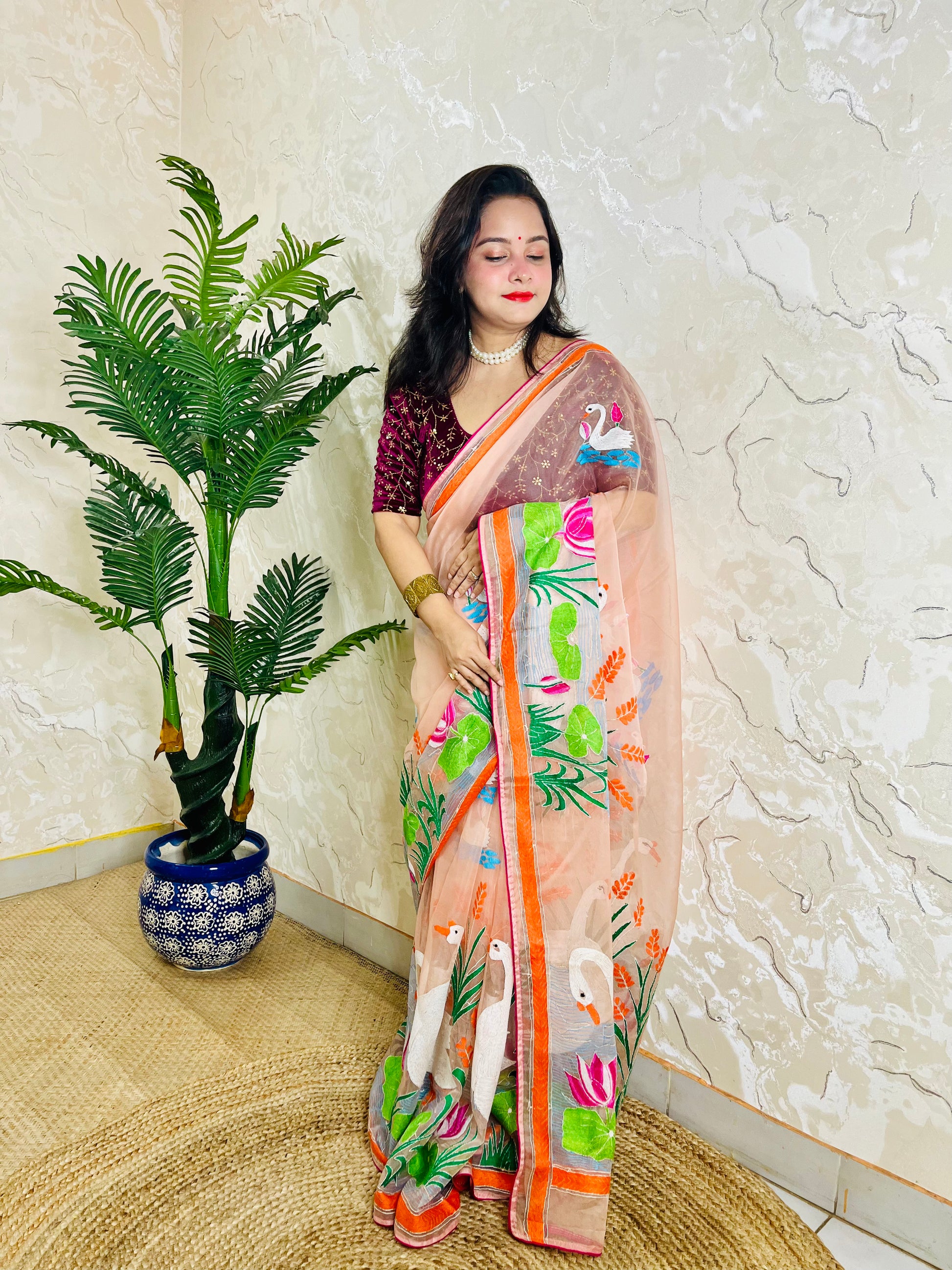 Detailed pallu close-up of handcrafted swan and lotus Kantha embroidery on sheer organza saree fabric