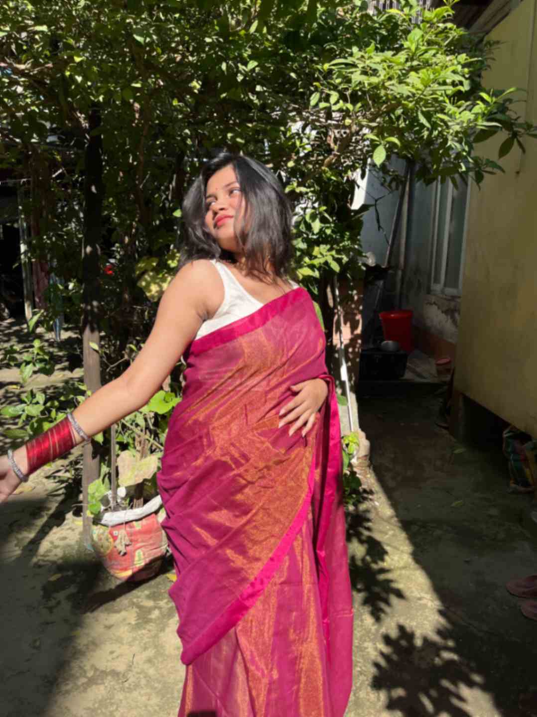 Close-up of golden zari on Maroon linen saree fabric