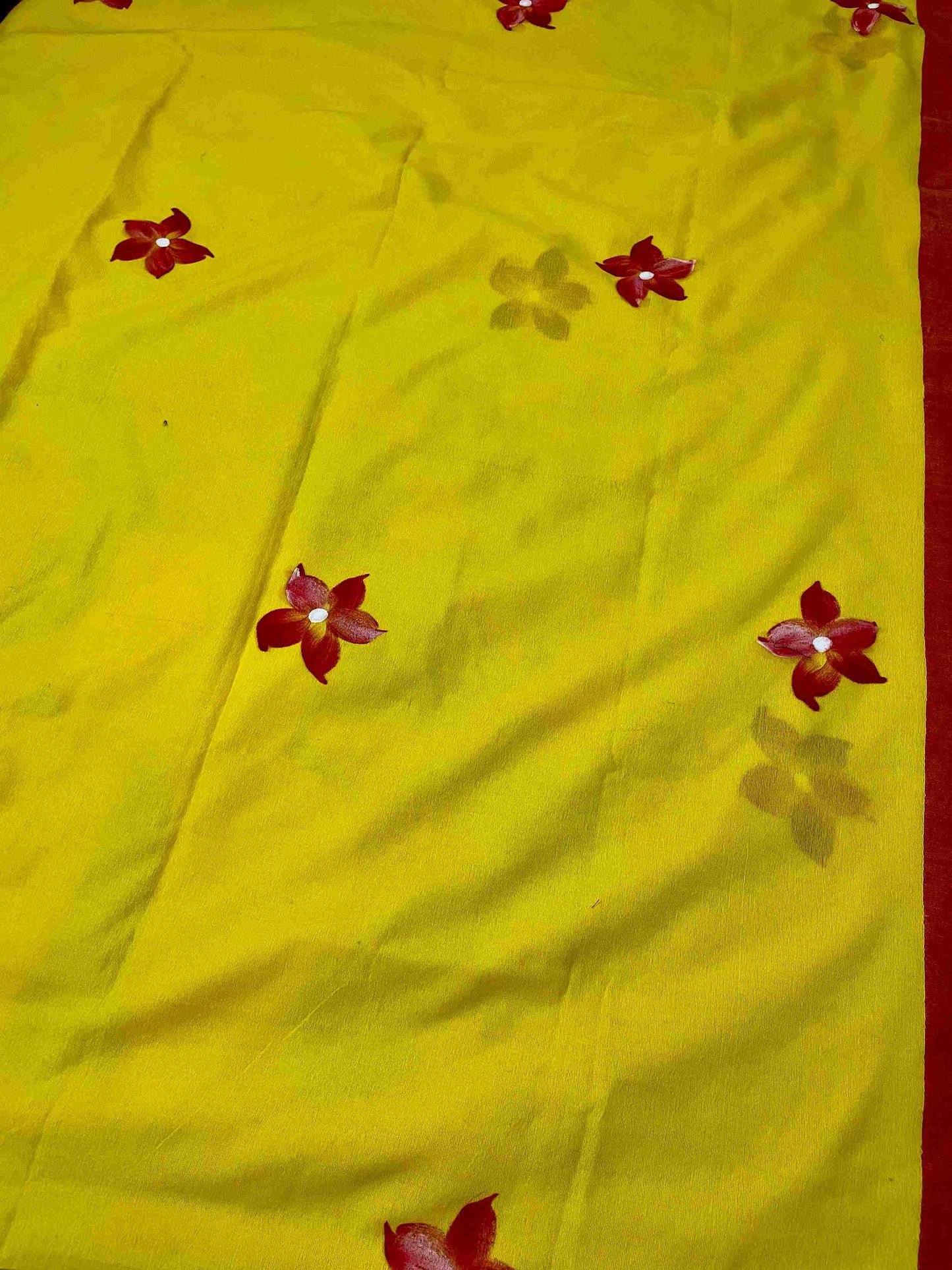 Close-up of hand-painted doll design on Yellow mul mul cotton saree