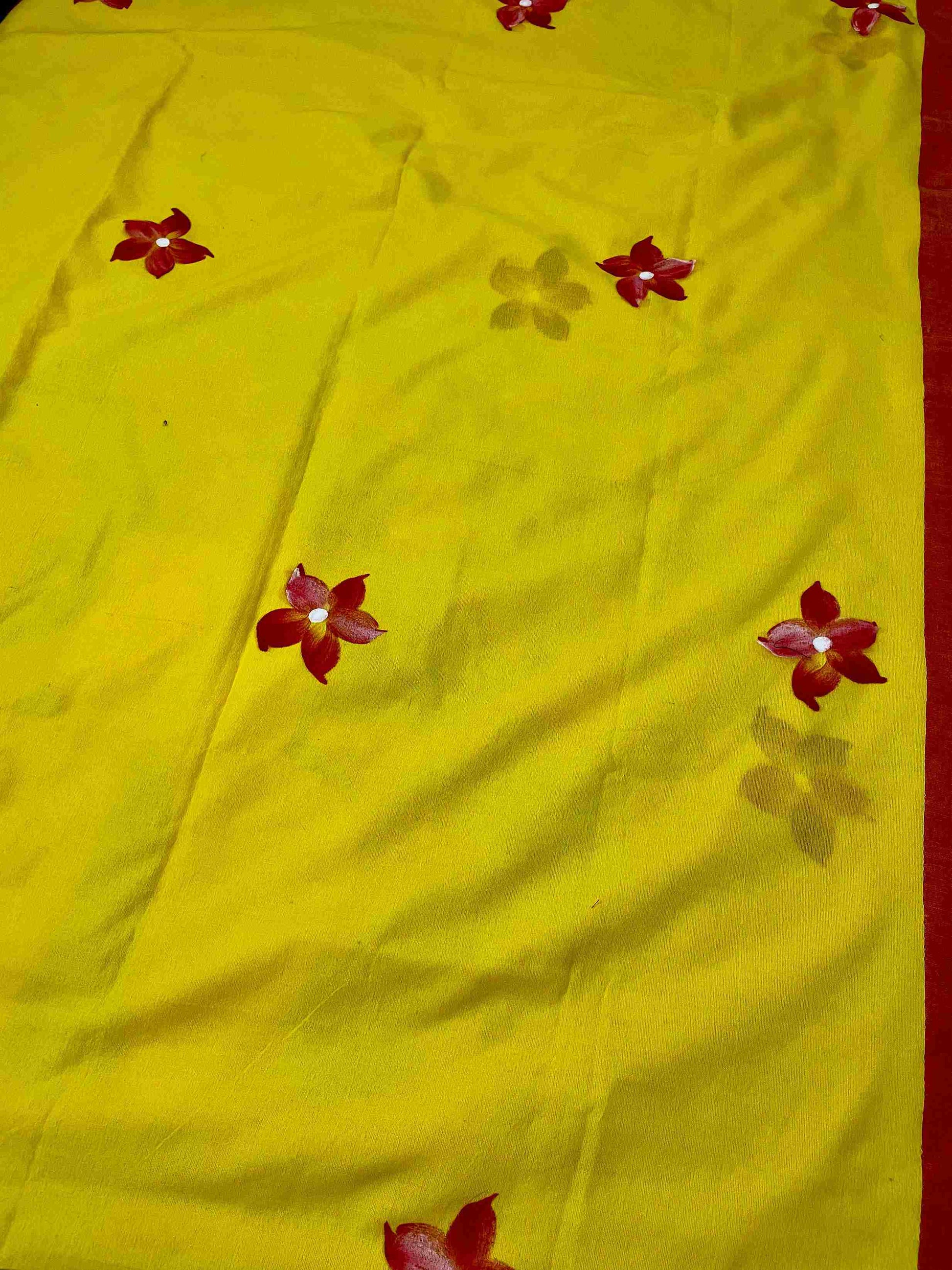 Close-up of hand-painted doll design on Yellow mul mul cotton saree