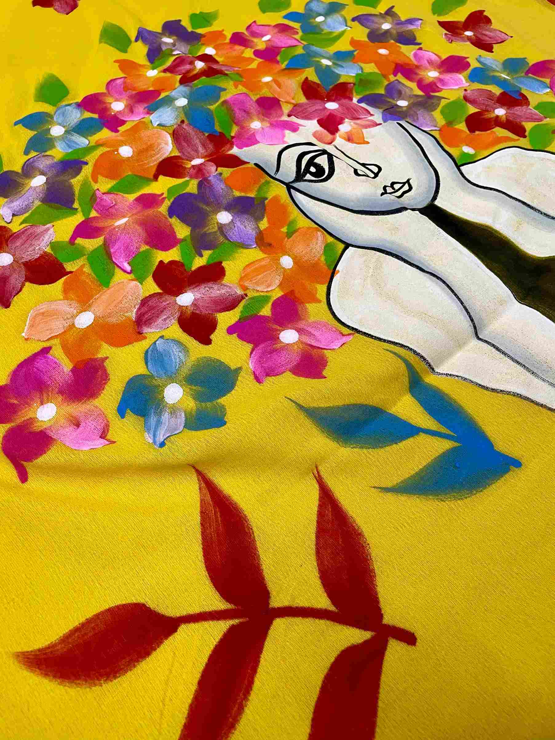 Close-up of hand-painted doll design on Yellow mul mul cotton saree