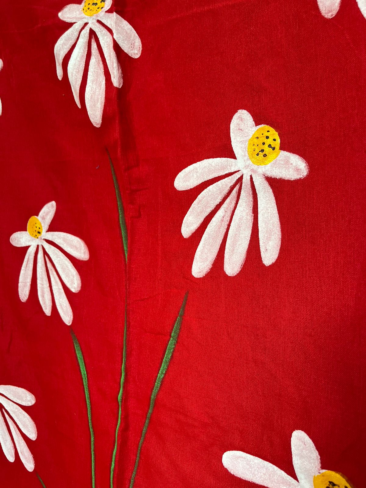 Close-up of hand-painted Shapla design on Red mul mul cotton saree