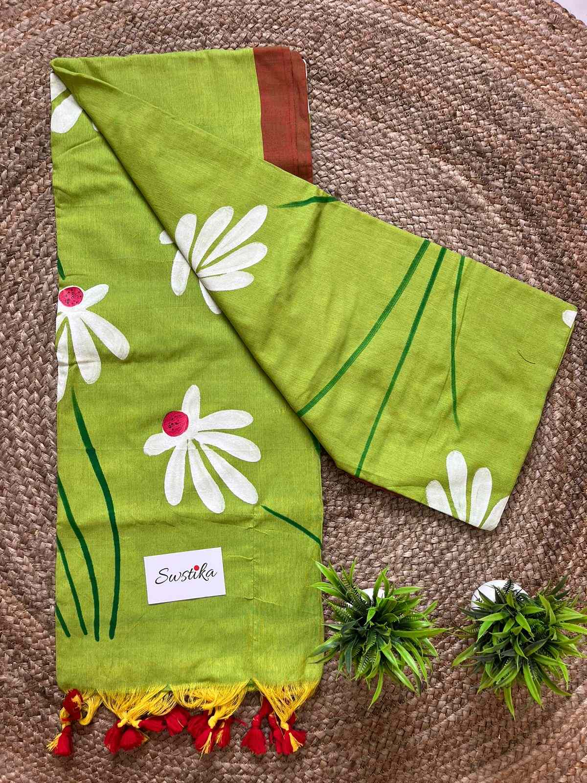 Close-up of hand-painted Shapla design on Green mul mul cotton saree
