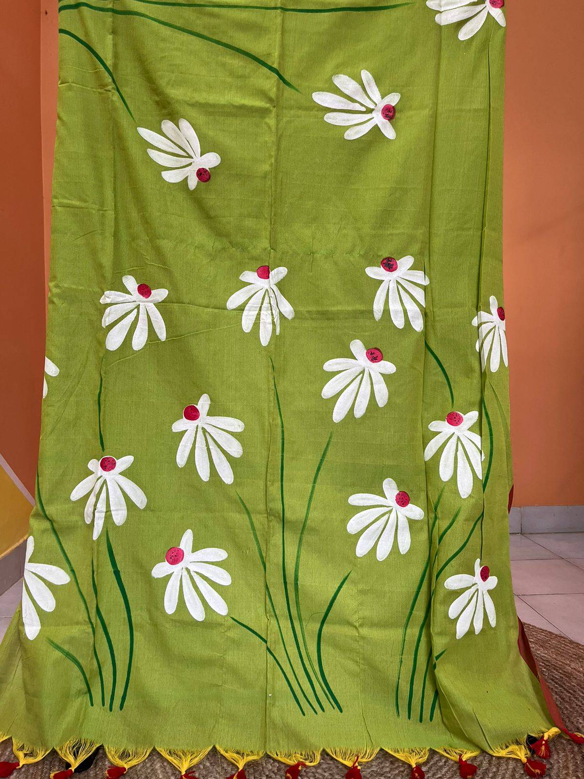 Close-up of hand-painted Shapla design on Green mul mul cotton saree