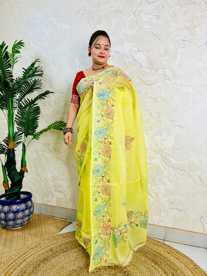 Front standing view of pastel yellow semi Tussar saree with hibiscus vine embroidery