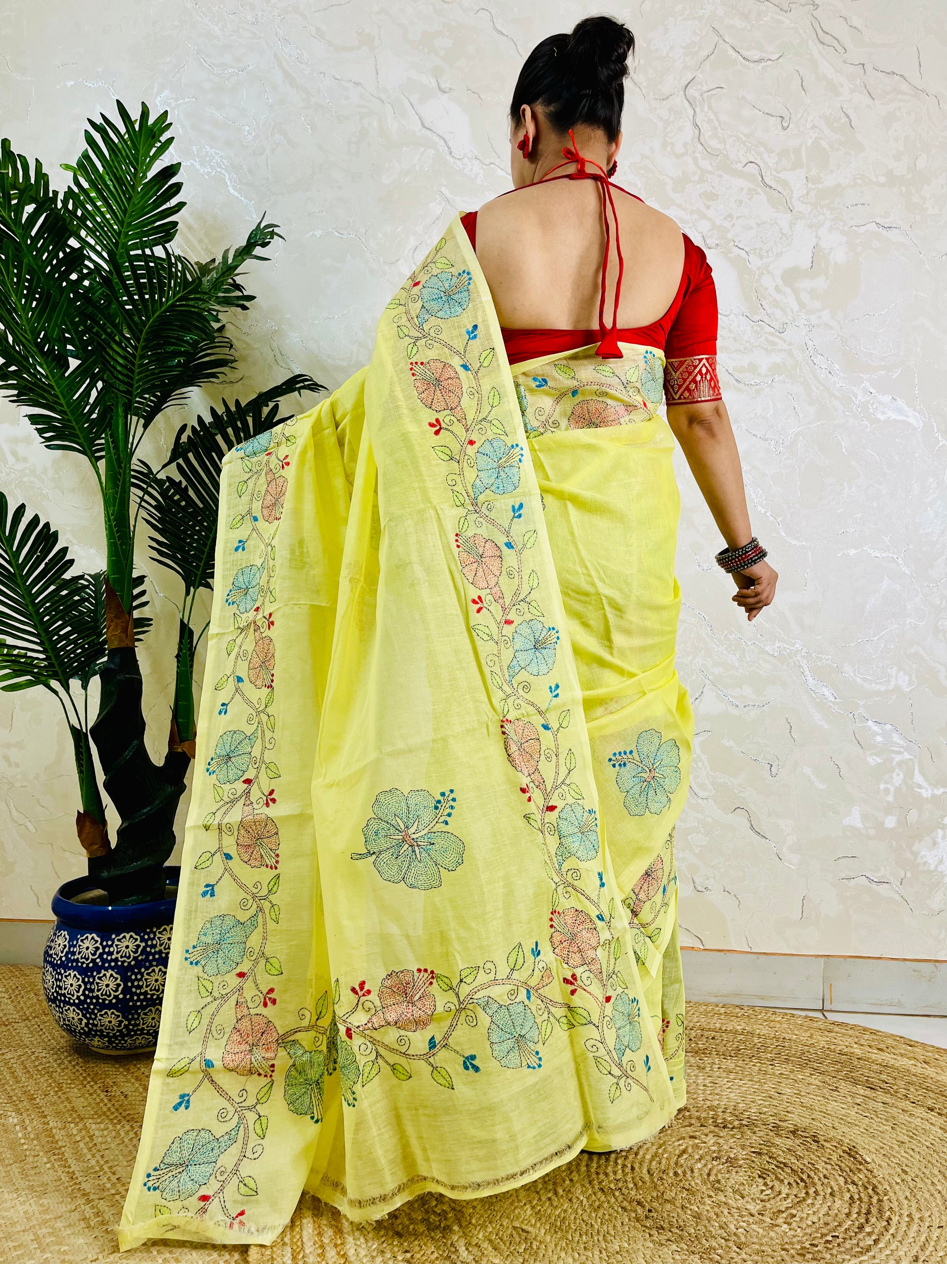 Pastel yellow Kantha stitch saree on semi Tussar silk, back standing view