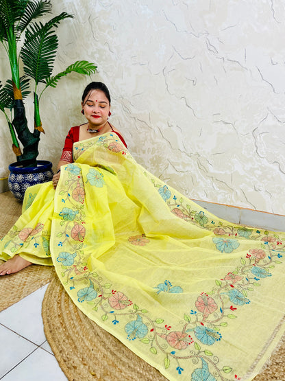 Seated view of pastel yellow Tussar silk saree with hand-embroidered floral border
