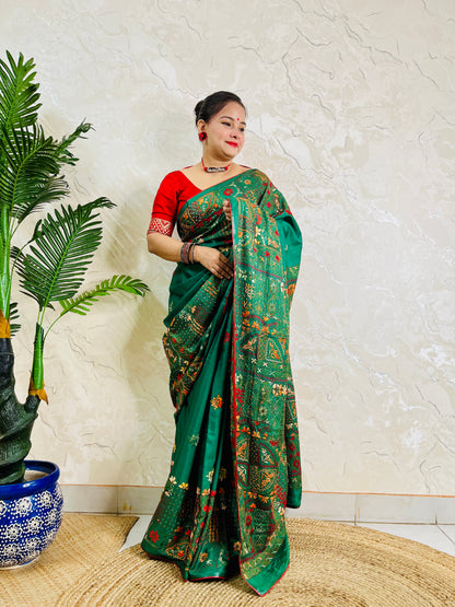Woman standing in emerald green Bangalore silk saree with Lambani embroidery