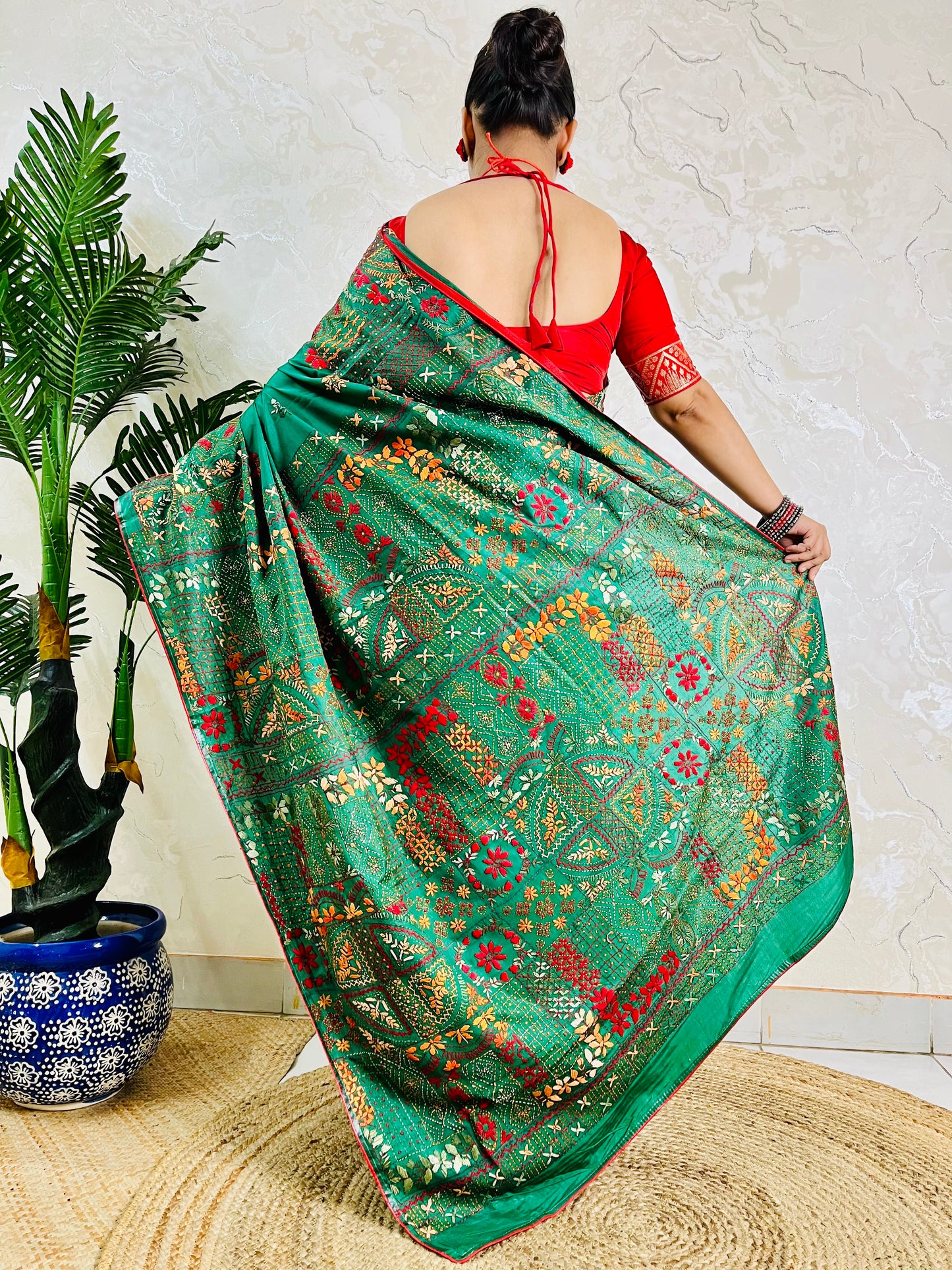 Back standing view of emerald green Lambani saree, pallu draped over shoulder