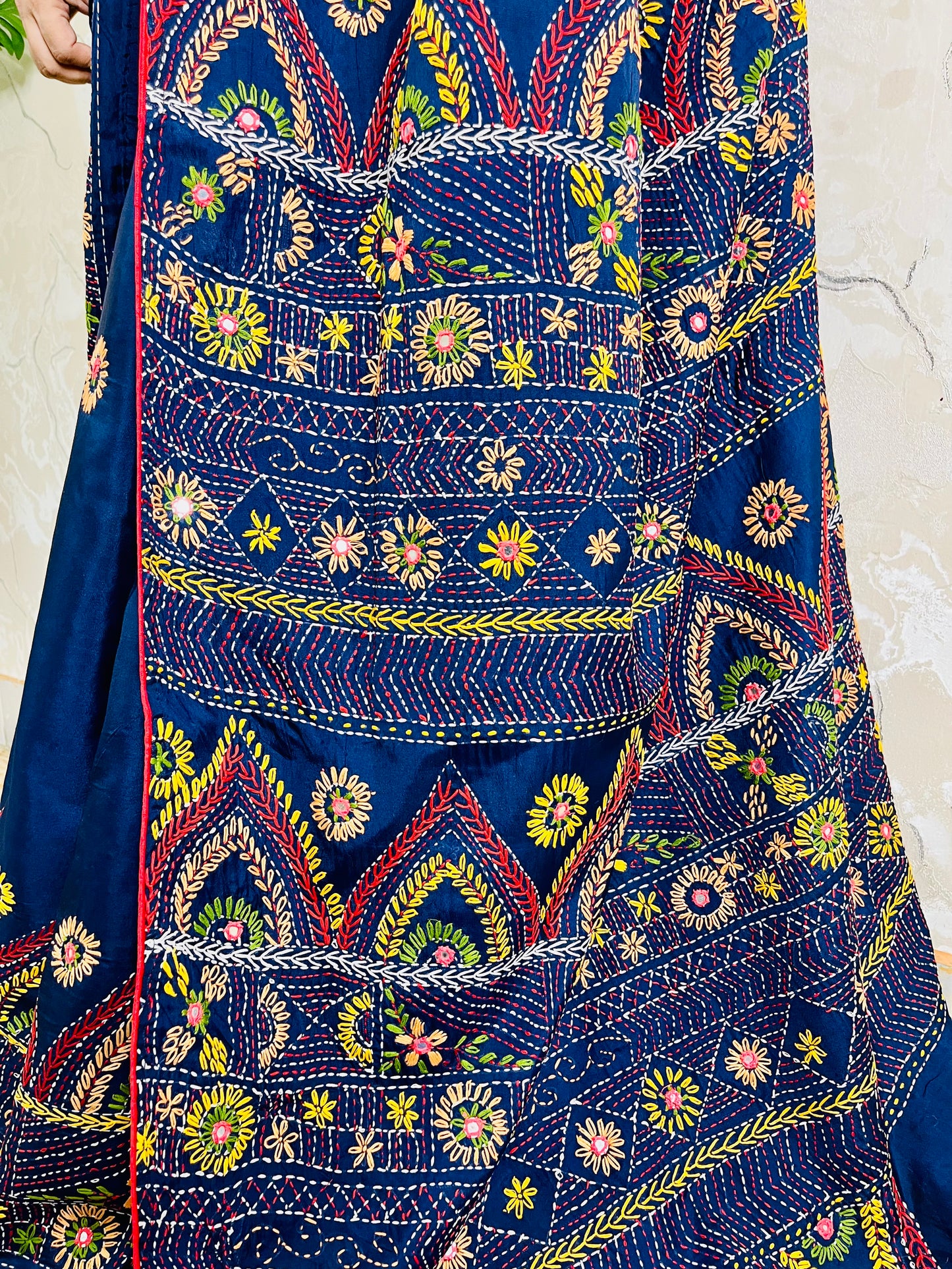 Close-up detail of arch pattern Lambani embroidery on deep indigo silk saree
