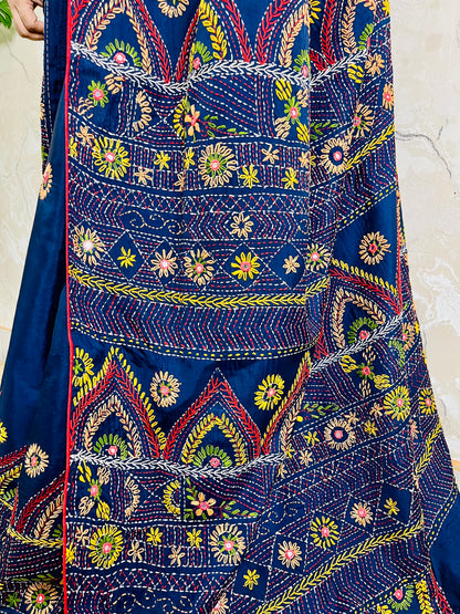 Close-up detail of arch pattern Lambani embroidery on deep indigo silk saree