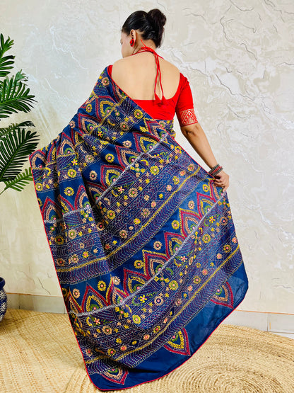 Deep indigo Lambani saree with red and gold arch motif embroidery, back standing view