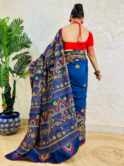 Deep indigo Lambani saree with red and gold arch motif embroidery, back standing view