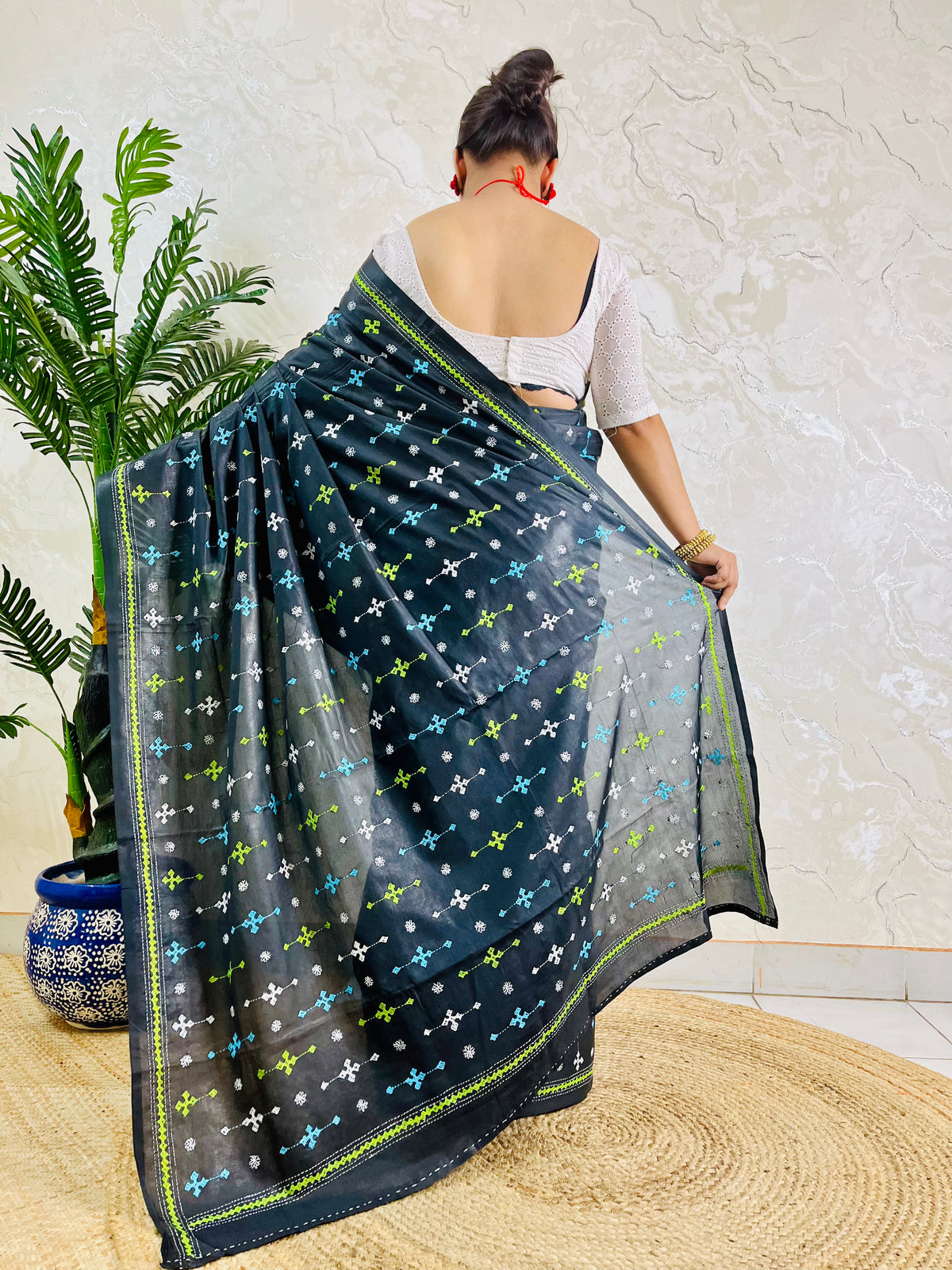 Back view showing black saree blouse and Gujarati stitch embroidery pattern