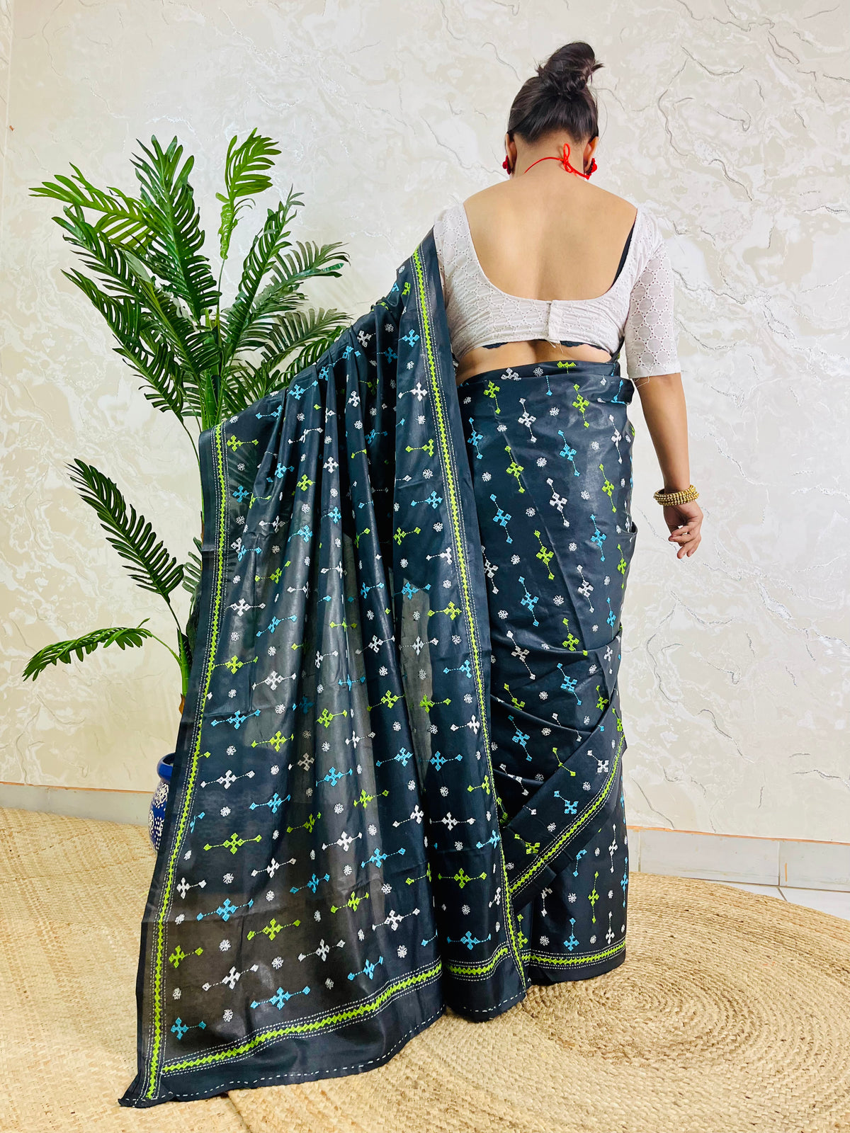 Back view showing black saree blouse and Gujarati stitch embroidery pattern