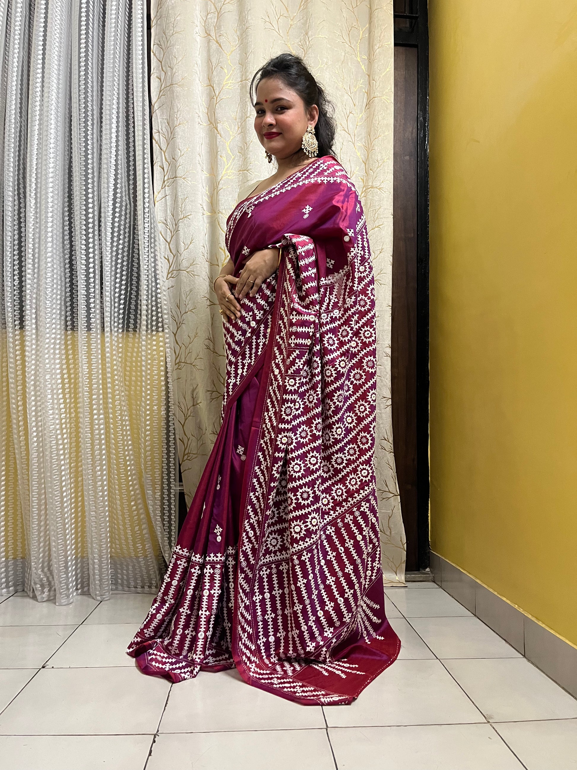 A women wearing Wine red Gujarati Stitch Saree with precise Kutch geometric hand embroidery and mirror work by Desi Aadat